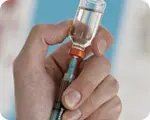 Syringe_vile_hands.webp